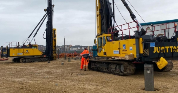 Driven Piling Machines Working on Site. Two Engineers Working