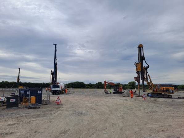 Three Piling Rigs And One Excavator Being Operated By Workers For Ground Improvement And Piling Works In Avonmouth.