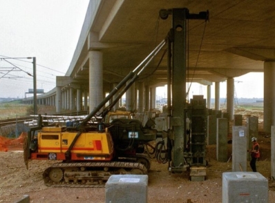 Railway construction site with workers and heavy machinery