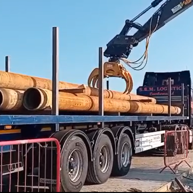 Crane Picking Piles From Truck