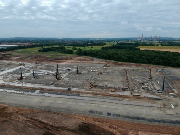 Aerial view of a precast reinforced concrete piles being installed. Heavy equipment and piling rigs is on site.
