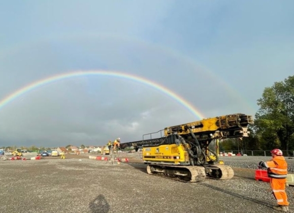 a rainbow shines over an active work site