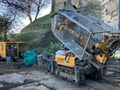 A yellow Klemm 702 drilling rig positioned at an angle.