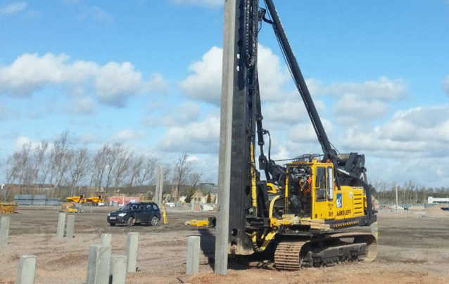 Aarsleff's Banut 700 rig being operated to install square precast concrete piles on a construction site.