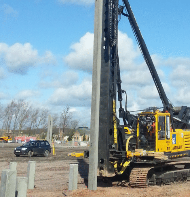 Aarsleff's Banut 700 rig being operated to install square precast concrete piles on a construction site.